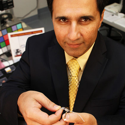 Mark Humayun, who is holding the Argus II artificial retina implant, plans to emphasize clinical, research and educational missions as director of the USC Eye Institute. (Photo by Jon Nalick)