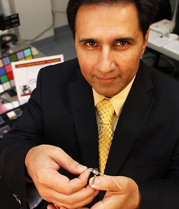 Mark Humayun, who is holding the Argus II artificial retina implant, plans to emphasize clinical, research and educational missions as director of the USC Eye Institute. (Photo by Jon Nalick)