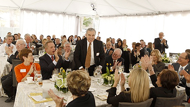 Attendees applaud Edward P. Roski, chairman of the USC Board of Trustees, during the V.I.P. luncheon. (Photo by Steve Cohn)