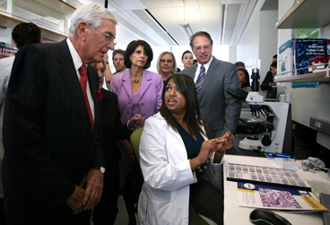 On a tour of the building, Eli Broad gets a science lesson from Dilani Rosa as U.S. Congresswoman Lucille Roybal-Allard and CIRM Chairman Robert Klein look on.