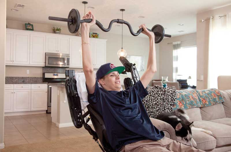 A car accident left Kris Boesen paralyzed. Experimental stem cell surgery gave him a chance to regain mobility in his arms and hands. (Photo by Greg Iger)
